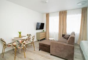 a living room with a couch and a table at Central Station Apartment No8 in Kaunas