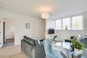 a living room with a couch and a glass table at Luxury 2-Bedroom Formby Property in Formby