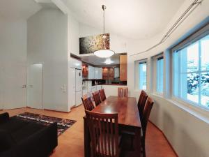 a kitchen and dining room with a table and chairs at Semi-detached house with sauna & yard near city center in Hyvinkää