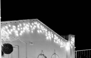 a white building with lights on the side of it at Sfumature di Puglia in Turi