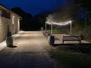 a row of park benches with lights at night at Camping Fargogne in Puygaillard-de-Quercy