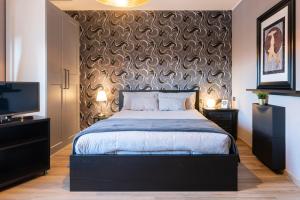 Un pat sau paturi într-o cameră la Villaggio Junior - bambnb