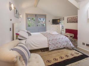 a bedroom with a large bed and a couch at Quay Cottage: Right on the Quay: Dittisham: Dartmouth: Devon at its best in Dittisham