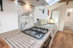 a kitchen with a stove top on a counter at Inviting 2-bed Home in Lincoln by Renzo, Stunning Countryside Location, Free Parking! in Stow