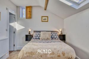 a bedroom with a large bed in a white room at Inviting 2-bed Home in Lincoln by Renzo, Stunning Countryside Location, Free Parking! in Stow