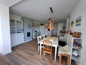a kitchen and dining room with a table and chairs at Lamsoor 9C in Nieuwvliet