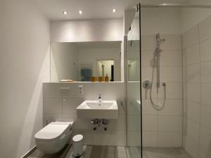 a bathroom with a toilet and a sink and a shower at Bootshaus Am Neuen Hafen in Bremerhaven