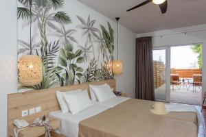 a bedroom with a bed with a tropical mural on the wall at Eurohotel Theo Hotel in Agia Marina Nea Kydonias
