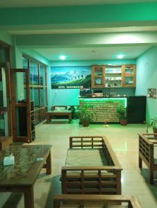 a room with tables and a mural on the wall at Hotel Sarangkot in Pokhara