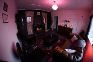 a living room with a couch and a fireplace at Charming apartment in central Stavanger in Stavanger