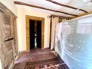 a hallway of a house with a doorway with a wall at White bay pianoB in Watamu +32 photos