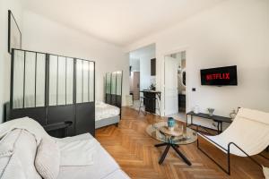 a living room with a couch and a table at Hypercentre - Palais - Croisette - Beach in Cannes