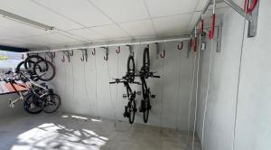 a garage with bikes hanging on the wall at Camping Bungalow el Llac de Banyoles in Porqueres