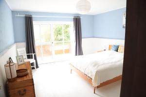 a bedroom with a bed and a large window at Ferienhaus 4 Peaks in Bayerisch Gmain