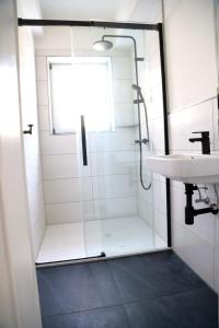 a bathroom with a shower and a sink at Ferienhaus 4 Peaks in Bayerisch Gmain