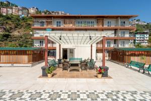 a patio with a table and chairs in front of a building at Rizell Alexis in Shimla