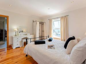 a bedroom with a large bed with a mirror at 2 bed property in Ventnor 82973 in Wroxall