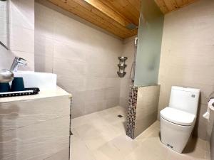 a bathroom with a white toilet and a shower at Nanwan 166 in Nanwan