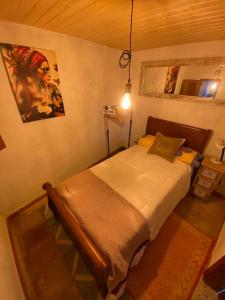 a bedroom with a bed in a room with a lamp at La Casita Encendida in Villamayor de Campos