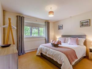 a bedroom with a bed with a teddy bear on it at 2 bed in Moreton in Marsh 83379 in Blockley