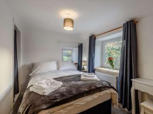 a bedroom with a large bed with a window at 2 Bed in Skipton 83775 in Barnoldswick