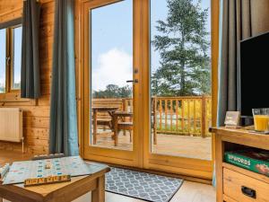 a living room with a door to a deck at 3 Bed in Lenham 86252 in Lenham