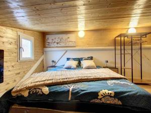 a bedroom with a bed in a wooden wall at Le Wilson Cosy in Dijon