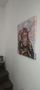 a painting of a monkey hanging on a wall at Le Wilson Cosy in Dijon