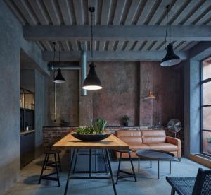 a living room with a table and a couch at The Emerald in Prague