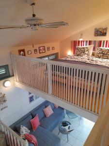 a living room with a blue couch and a bed at LUKA- cozy apartment in Gajac +20 photos