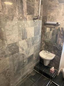 a bathroom with a sink and a toilet at Central London Double Bedroom by Station in London
