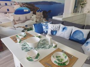 a table with white and blue dishes on it at CALTERR - Loft con Terraza privada, Wifi, Recién reformado in Torremolinos