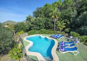an overhead view of a swimming pool with lounge chairs and a swimming pool at Owl Booking Villa Moragues - Surrounded By Nature in El Port