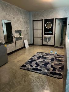 a bathroom with a sink and a rug on the floor at Sea Skyline family in Sattahip