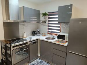 a small kitchen with a sink and a refrigerator at logement entier avec garage. in Rieux