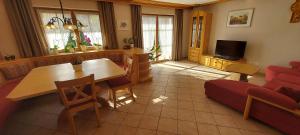 a living room with a table and a couch at Ferienhaus Molberting in Siegsdorf