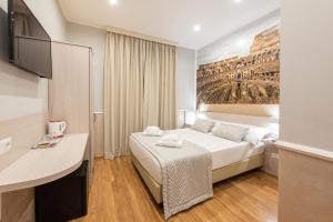 Postel nebo postele na pokoji v ubytování Top Floor Colosseo Guesthouse