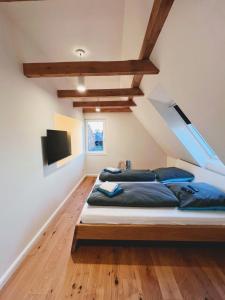 1 dormitorio con 1 cama grande con almohadas azules en Ferienwohnung-An-t-Osterdiek, en Nessmersiel
