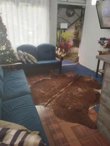 a living room with a couch and a rug at Pousada águia da serra in Gramado