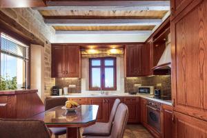 a kitchen with wooden cabinets and a table with a banana on it at Saridakis Villa, a multi-generational Retreat, By ThinkVilla in Roussospítion