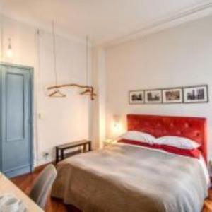 a bedroom with a large bed with a red headboard at Circus Maximus B&B in Rome