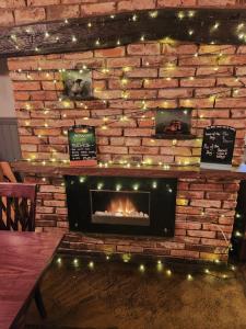 a brick wall with a fireplace with christmas lights at Red Lion Inn & Motel in York