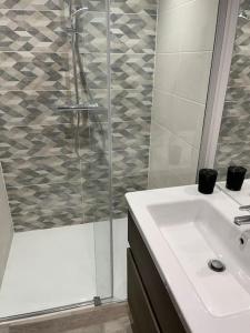 a bathroom with a shower and a sink and a sink at Loft relais Cœur de France in Vierzon +22 photos