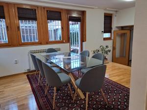 a dining room with a glass table and chairs at Villa Anni in Sarajevo