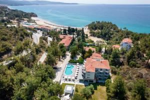 an aerial view of a resort with a pool and the ocean at Green Bay in Limenaria
