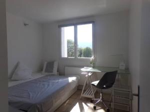 a bedroom with a bed and a desk and a window at Plus qu'à s'installer,pour des séjours télétravail in Rhut