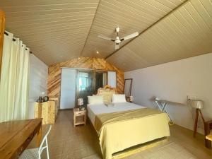 a bedroom with a bed and a ceiling fan at DucknChill-Agonda in Agonda