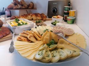 a plate of cheese and other foods on a table at Őri Art Inn in Őriszentpéter +58 photos