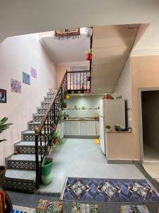 a room with a staircase and a refrigerator at Riad dar sahrawi in Marrakech