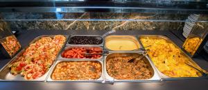 a bunch of trays of food in an oven at Green Bay in Limenaria